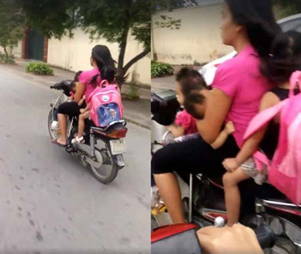 Mới đây, một đoạn clip dài hơn 30 giây ghi lại cảnh một người phụ nữ thản nhiên điều khiển xe máy bằng một tay trên đường phố Hà Nội. Trên xe, người phụ nữ đèo 3 đứa trẻ, tất cả đều không đội mũ bảo hiểm.