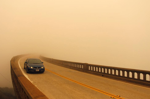 Khói từ đám cháy rừng có tên gọi Soberanes làm giảm tầm nhìn của các tài xế trên trên cầu Bixby ở bắc Big Sur, California