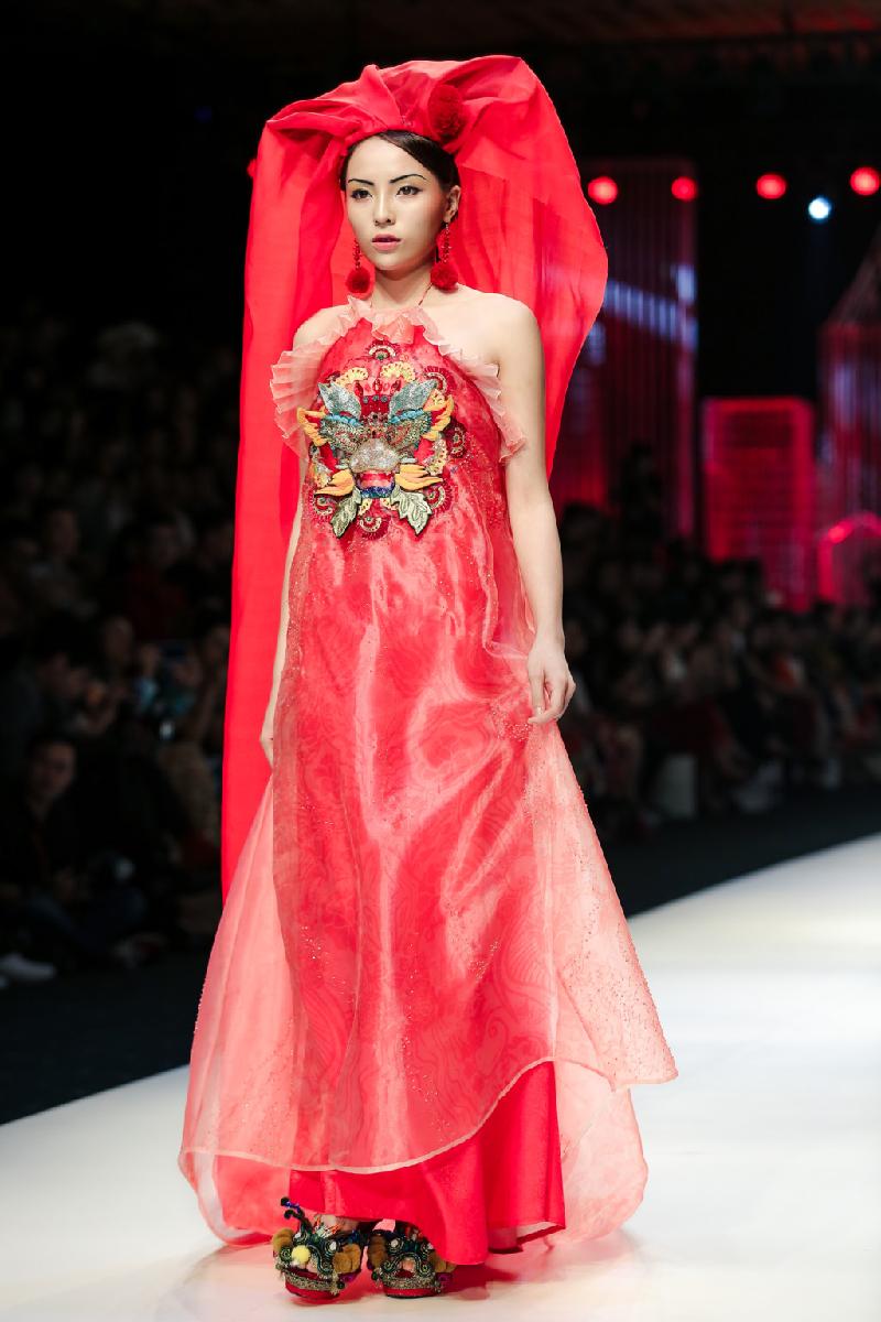 Điều đó thể hiện rõ nhất qua bộ trang phục mà Kỳ Duyên trình diễn ở cuối show. Cô mặc áo dài đỏ, kết hợp cùng khăn trùm đầu dài. Đây là lần đầu tiên người đẹp Nam Định đảm nhận vị trí vedette ở Vietnam International Fashion Week. 