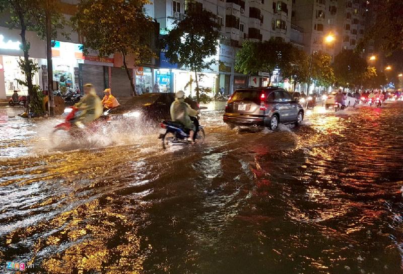 Cùng lúc này, tại phố Phạm Ngọc Thạch, nước mưa cũng ngập nửa bánh xe. Nhiều điểm ngập úng sâu khoảng nửa mét cũng xuất hiện tại các tuyến phố gần đó. Ảnh: Phong Lá Đỏ.